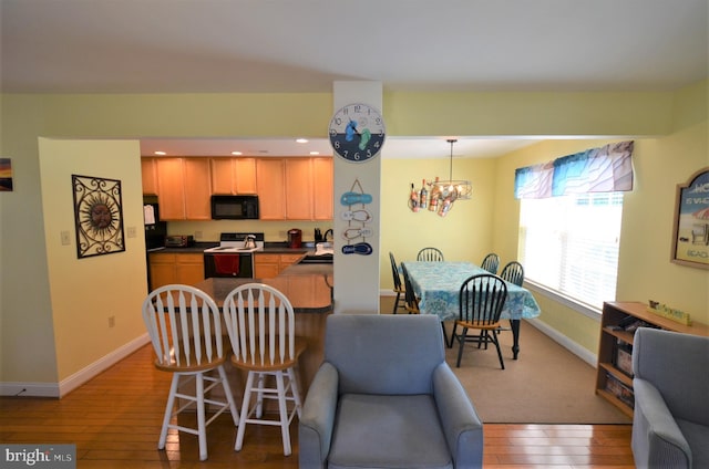 20324 Mallory Ct Unit 49, Rehoboth Beach, DE 19971 - dining space with light wood-type flooring, recessed lighting, baseboards, and an inviting chandelier