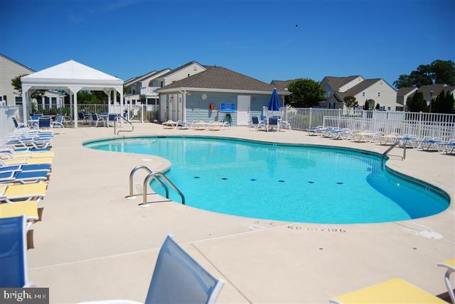 20324 Mallory Ct Unit 49, Rehoboth Beach, DE 19971 - community pool featuring fence, a patio, and a gazebo