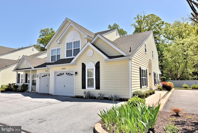 20324 Mallory Ct Unit 49, Rehoboth Beach, DE 19971 - traditional-style home with fence, roof with shingles, and aphalt driveway
