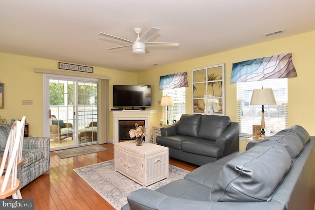 20324 Mallory Ct Unit 49, Rehoboth Beach, DE 19971 - living room with a ceiling fan, a glass covered fireplace, and hardwood / wood-style floors