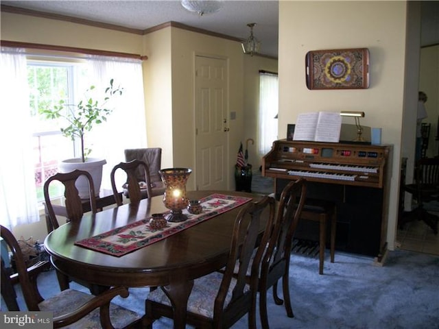 carpeted dining area featuring ornamental molding