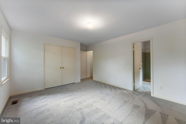 22 E Howell Ave, Alexandria, VA 22301 - unfurnished bedroom with carpet, baseboards, a closet, and connected bathroom