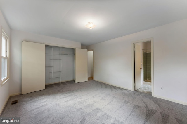 22 E Howell Ave, Alexandria, VA 22301 - unfurnished bedroom featuring light carpet, a closet, baseboards, and ensuite bathroom
