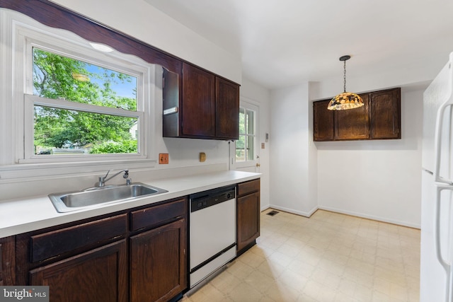 22 E Howell Ave, Alexandria, VA 22301 - kitchen featuring white appliances, a sink, light countertops, light flooring, and decorative light fixtures