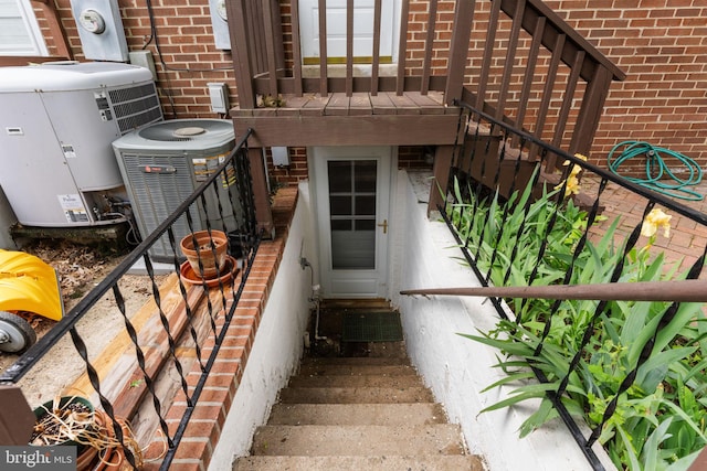 22 E Howell Ave, Alexandria, VA 22301 - doorway to property featuring brick siding and central AC unit