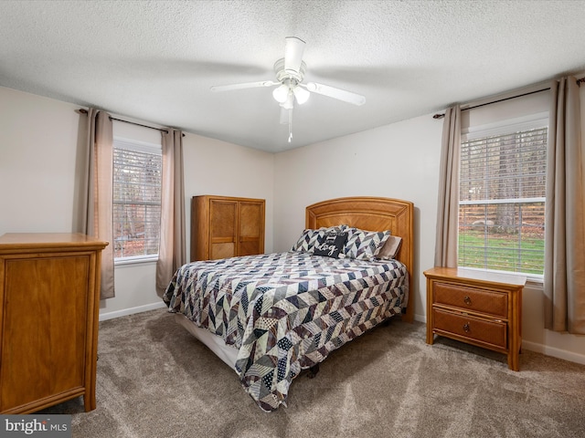 bedroom featuring ceiling fan, a textured ceiling, baseboards, and carpet floors