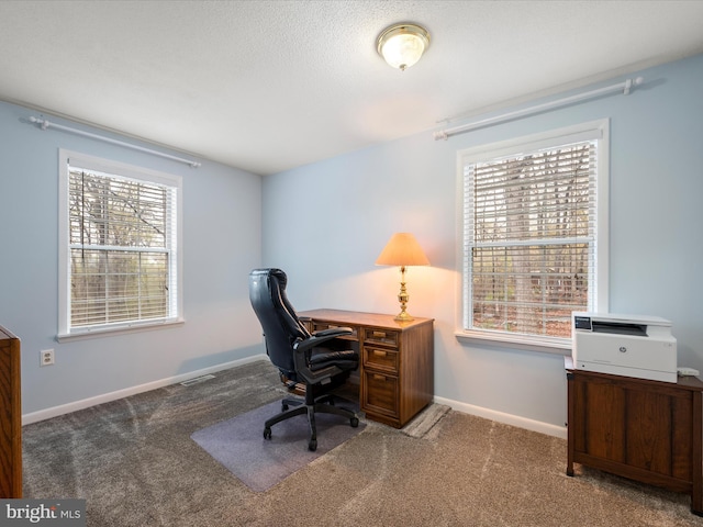 office area featuring visible vents, baseboards, and carpet