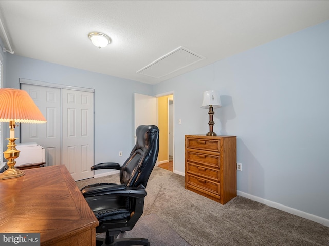 carpeted home office with baseboards and attic access