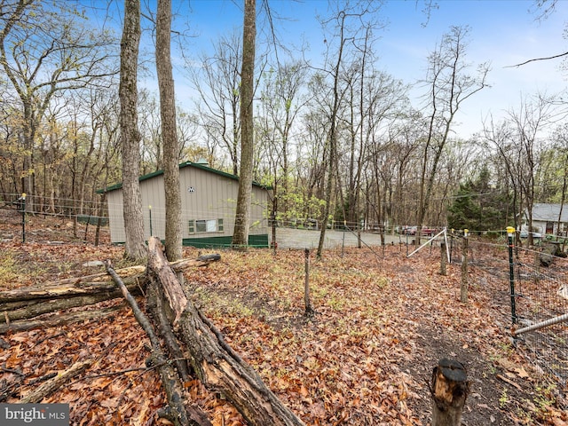 view of yard with fence and an outdoor structure