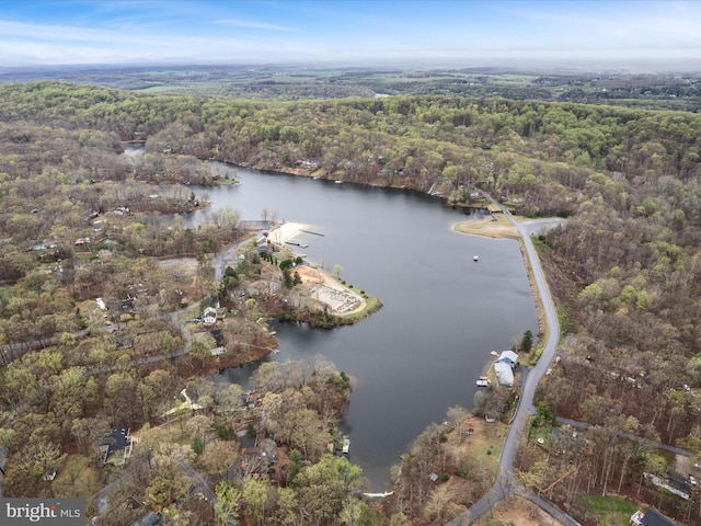 aerial view with a wooded view and a water view