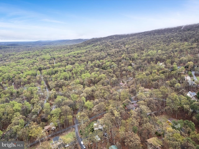 birds eye view of property featuring a view of trees