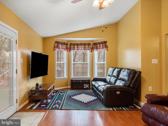 living area featuring wood-type flooring, a ceiling fan, vaulted ceiling, and a healthy amount of sunlight