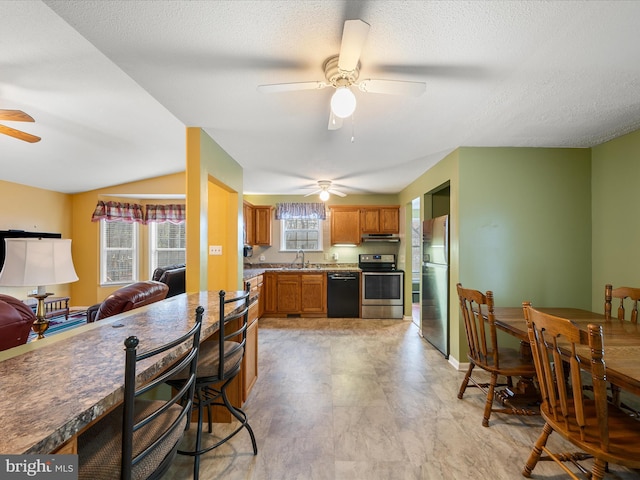 dining room featuring a textured ceiling and a ceiling fan