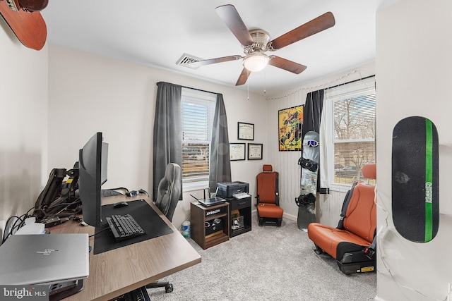 carpeted home office with visible vents and ceiling fan