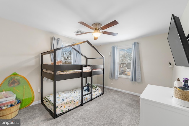 carpeted bedroom featuring baseboards, visible vents, and ceiling fan