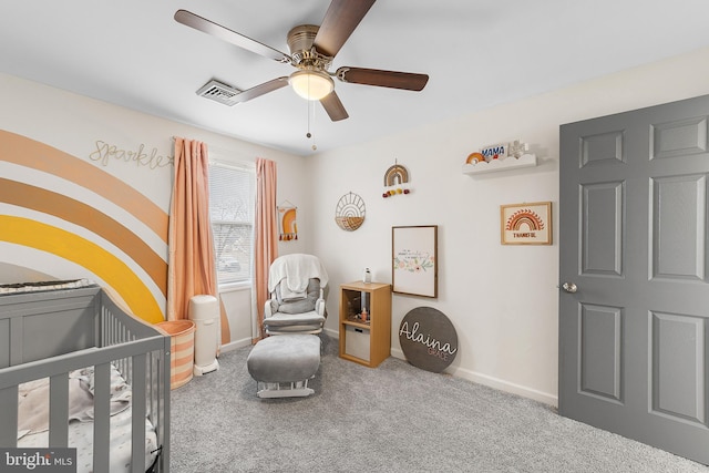 bedroom with a crib, carpet flooring, baseboards, and visible vents