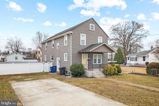 view of front of house with a front yard and fence