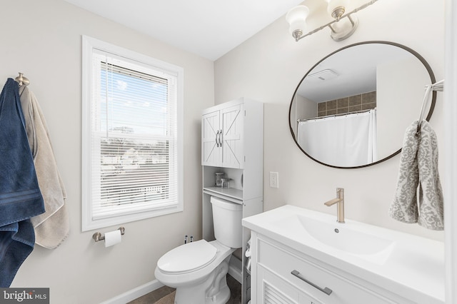 full bathroom featuring vanity, toilet, and baseboards