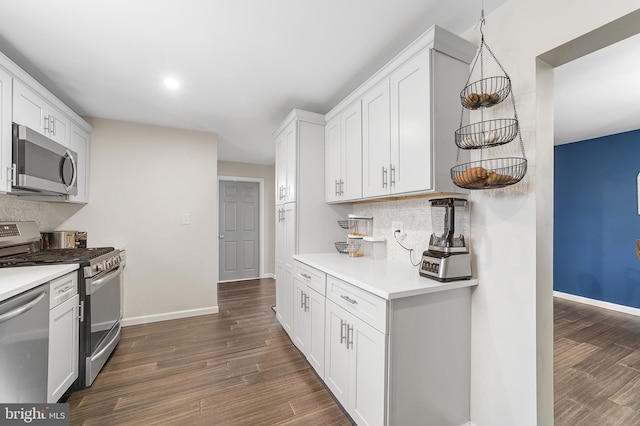 kitchen featuring dark wood-style floors, baseboards, stainless steel appliances, decorative backsplash, and light countertops