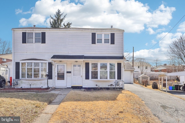 view of front of home featuring driveway, a garage, and a front lawn