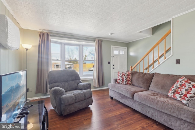 living room with baseboards, wood finished floors, stairway, and crown molding
