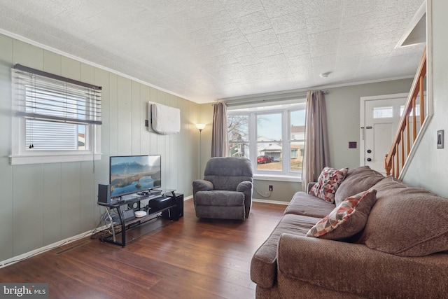 living room with baseboards, wood finished floors, and ornamental molding