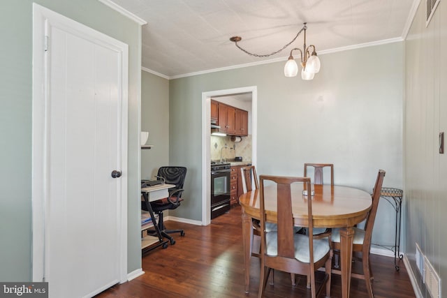 dining room featuring a notable chandelier, crown molding, baseboards, and dark wood finished floors