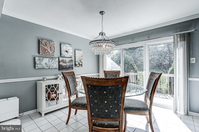 tiled dining area featuring plenty of natural light, ornamental molding, baseboards, and a notable chandelier