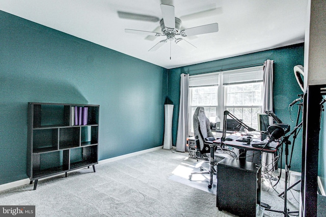 office featuring baseboards, a ceiling fan, and carpet floors