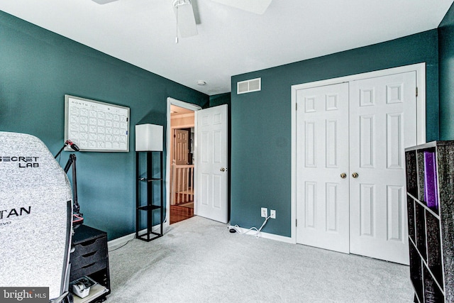 interior space featuring a ceiling fan, baseboards, visible vents, and a closet
