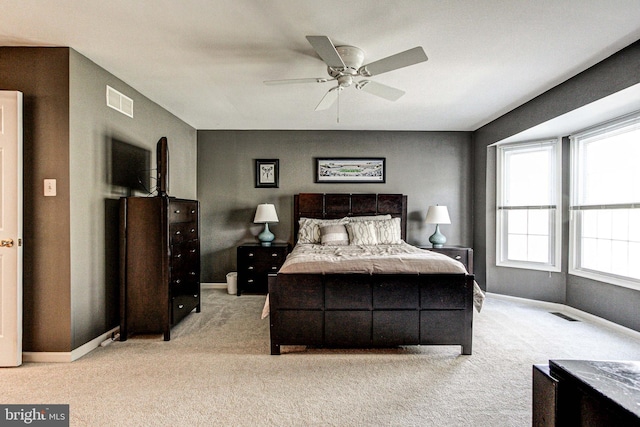 bedroom featuring carpet floors, baseboards, a ceiling fan, and visible vents