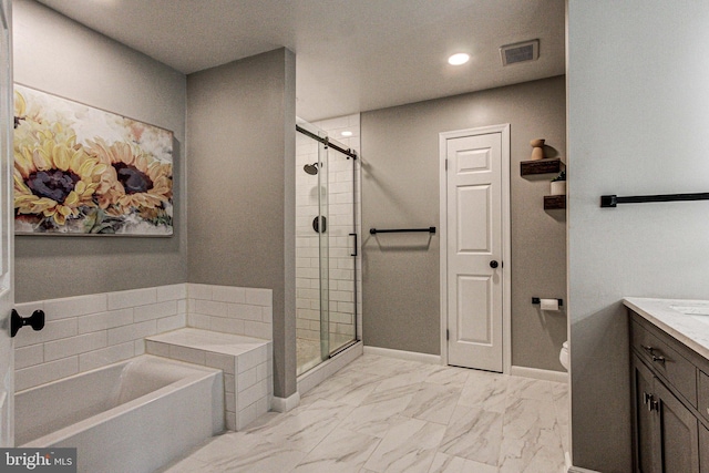 bathroom featuring marble finish floor, visible vents, a shower stall, and a garden tub