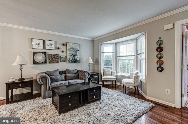 living area with baseboards, ornamental molding, dark wood-style floors, and visible vents