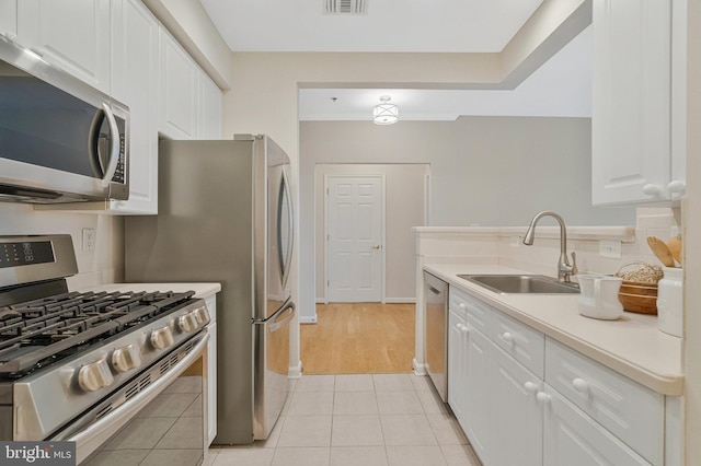 1860 Stratford Park Pl Unit 306, Reston, VA 20190 - kitchen featuring a sink, white cabinetry, light countertops, and appliances with stainless steel finishes