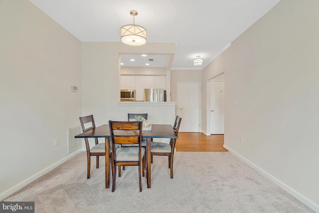 1860 Stratford Park Pl Unit 306, Reston, VA 20190 - dining area featuring baseboards, light carpet, and visible vents