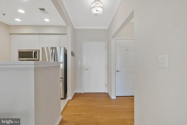 1860 Stratford Park Pl Unit 306, Reston, VA 20190 - hall with visible vents, recessed lighting, crown molding, light wood-style flooring, and baseboards