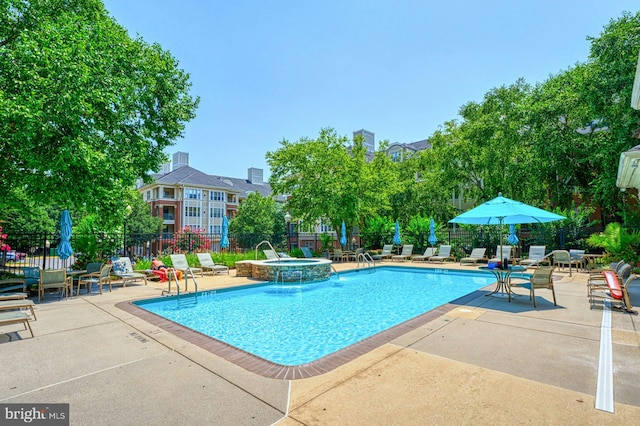 1860 Stratford Park Pl Unit 306, Reston, VA 20190 - view of pool with a pool with connected hot tub, a patio area, and fence