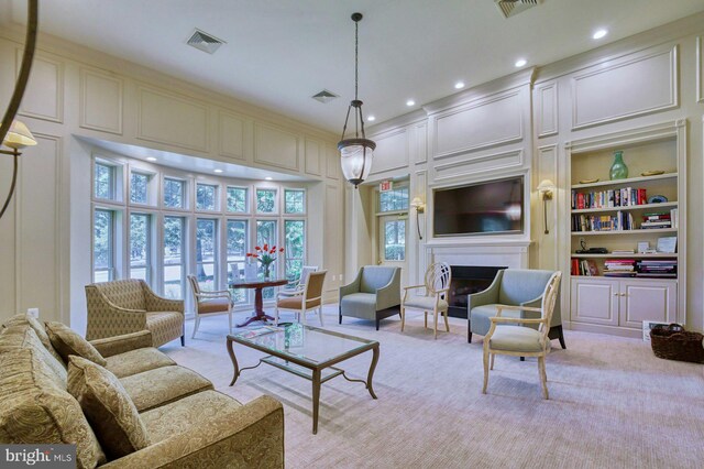 1860 Stratford Park Pl Unit 306, Reston, VA 20190 - living area featuring recessed lighting, a fireplace, a decorative wall, and visible vents