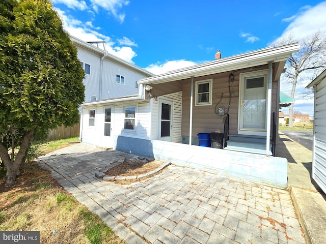 back of property featuring a patio and fence