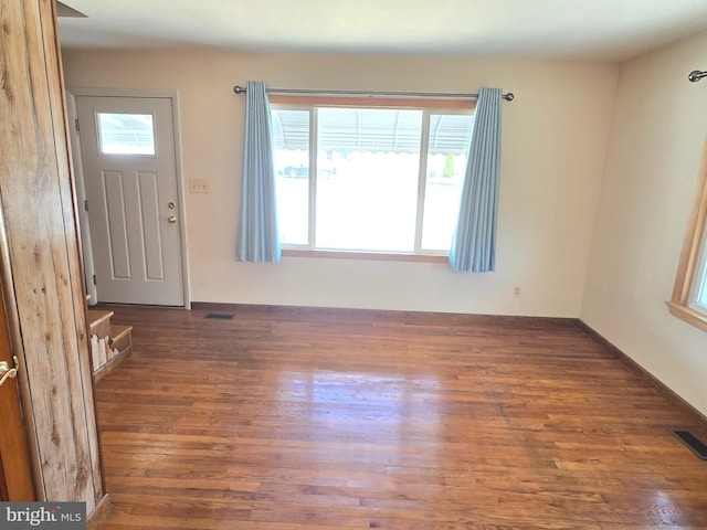 foyer with wood finished floors and visible vents