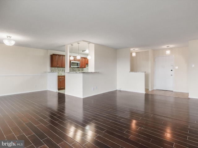 309 Yoakum Pkwy Unit 1003, Alexandria, VA 22304 - unfurnished living room with baseboards and wood finished floors