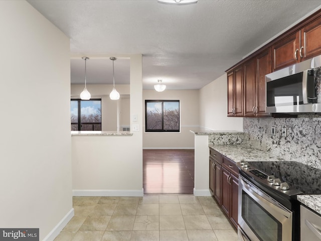 309 Yoakum Pkwy Unit 1003, Alexandria, VA 22304 - kitchen featuring stainless steel appliances, backsplash, light tile patterned floors, and light stone counters