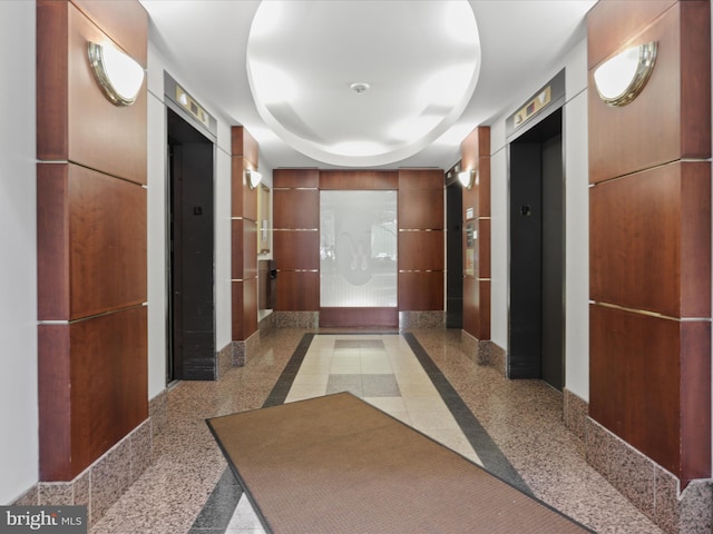 309 Yoakum Pkwy Unit 1003, Alexandria, VA 22304 - corridor with elevator, a tray ceiling, baseboards, and granite finish floor