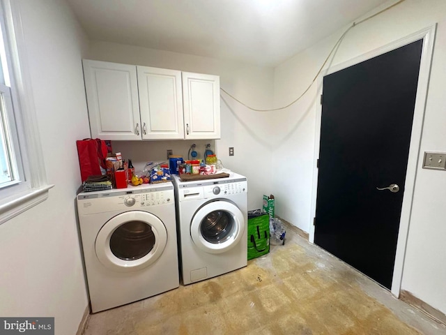 clothes washing area with cabinet space and washing machine and dryer