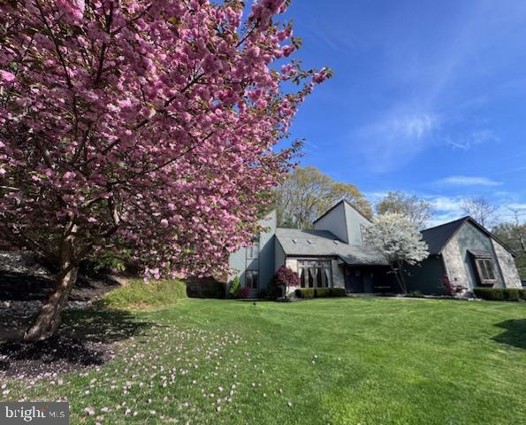 view of side of home featuring a lawn