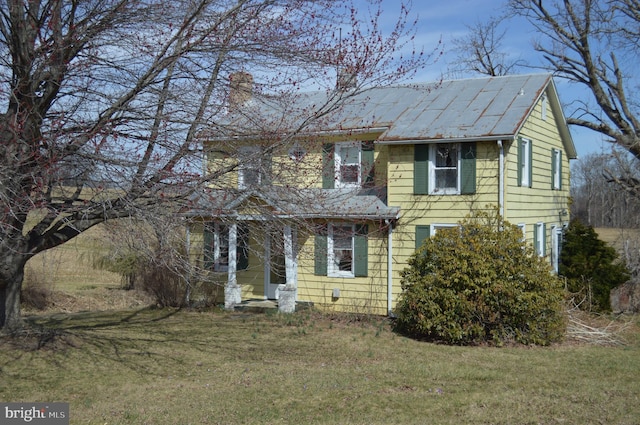 traditional home with a front lawn and a chimney