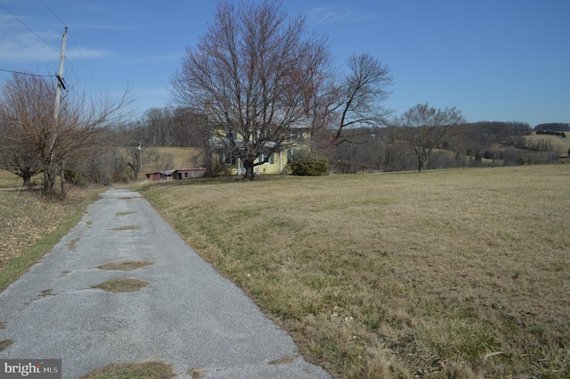 view of road featuring a rural view and driveway