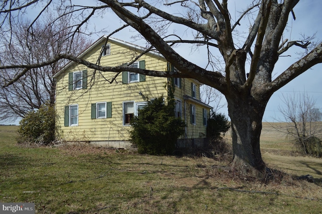 view of property exterior with a yard