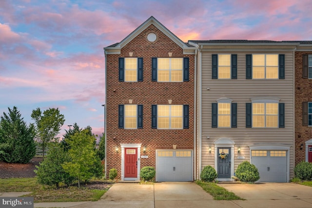 view of property featuring an attached garage and driveway