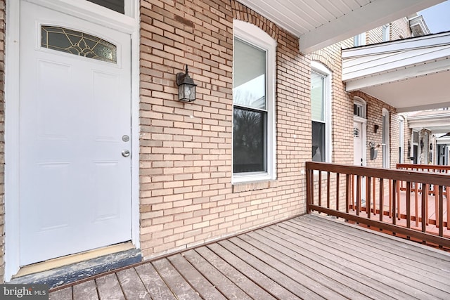 doorway to property with brick siding